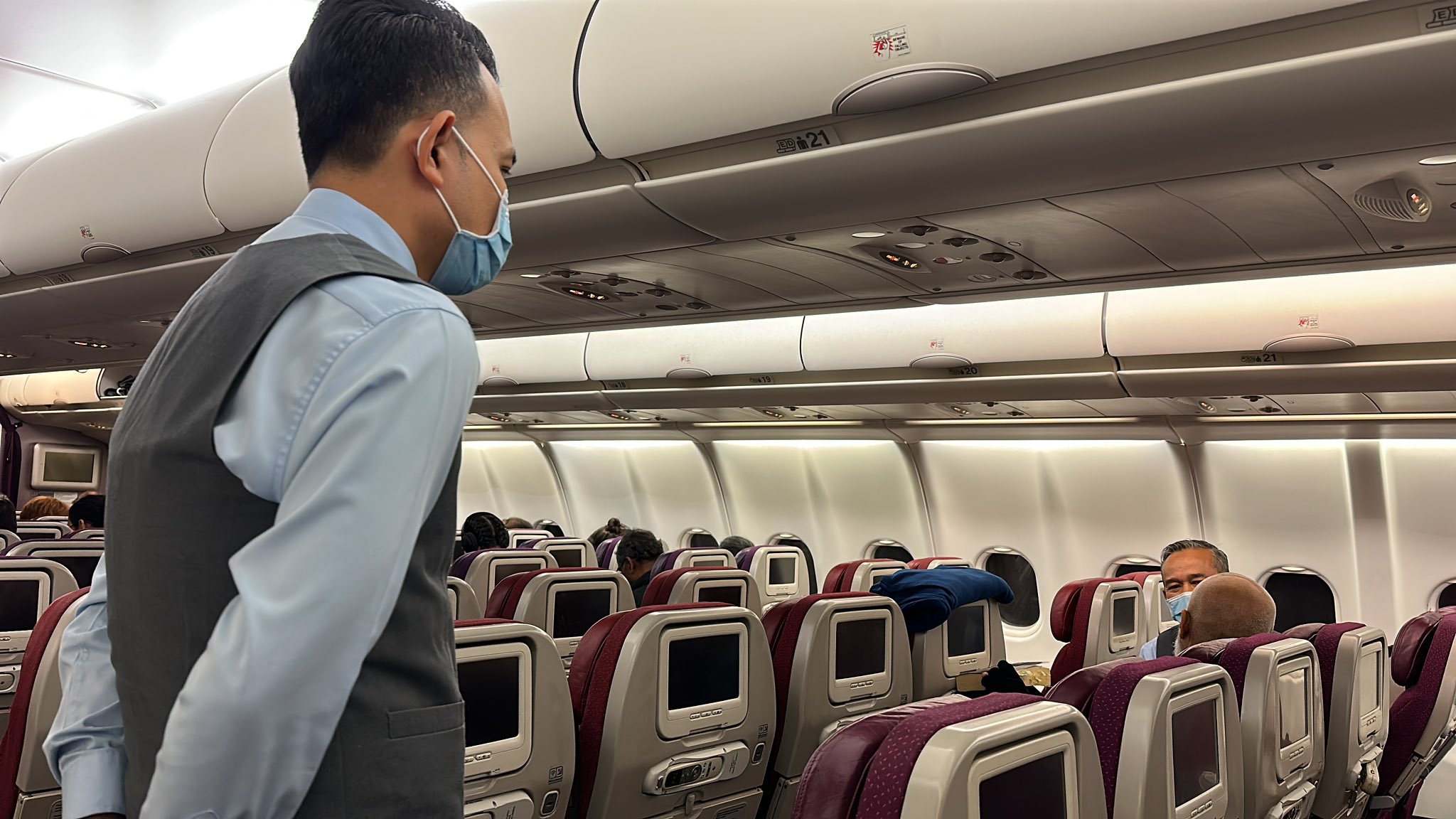 MH122 cabin crew sitting and listening to the disruptive passenger (Photo: X/chzaib)