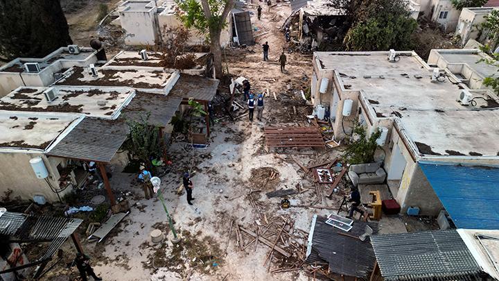 The aerial view shows members of the media visiting Kibbutz Kfar Aza, following a deadly attack by the armed group Hamas from the Gaza Strip in southern Israel on Sunday (15 Oct). (Photo: REUTERS).