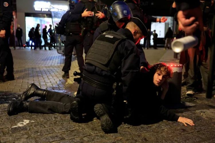 French law enforcement detains a demonstrator at an unauthorized rally advocating for the Palestinian cause in Lille. (Photo: Reuters)