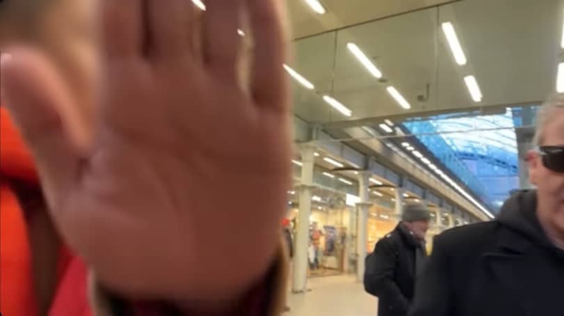 One of the men from the Chinese nationals group covered the camera lens from recording his face